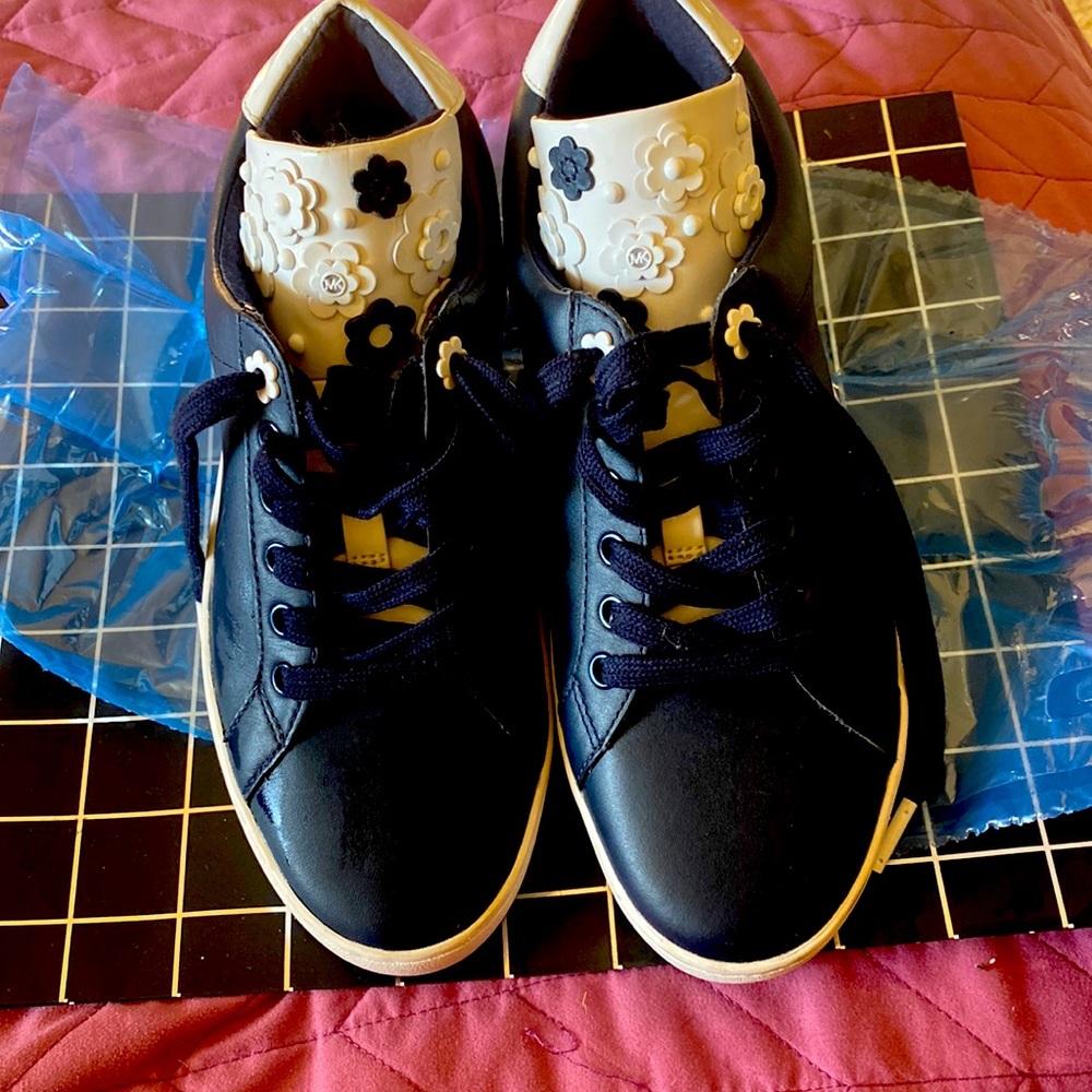 ( Michael Kors) :Original Blue+white floral decals leather rubber consoles.